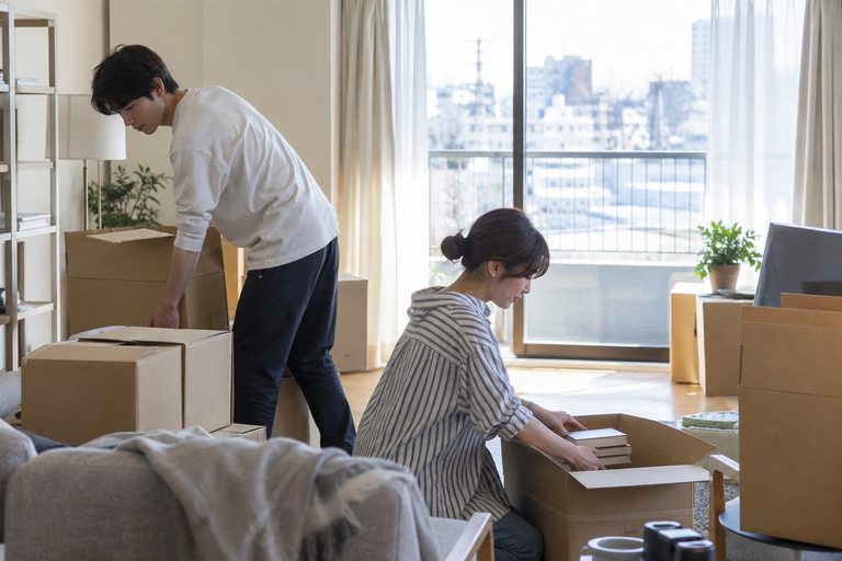 窓辺に段ボールが積まれた、住み替え前の部屋
